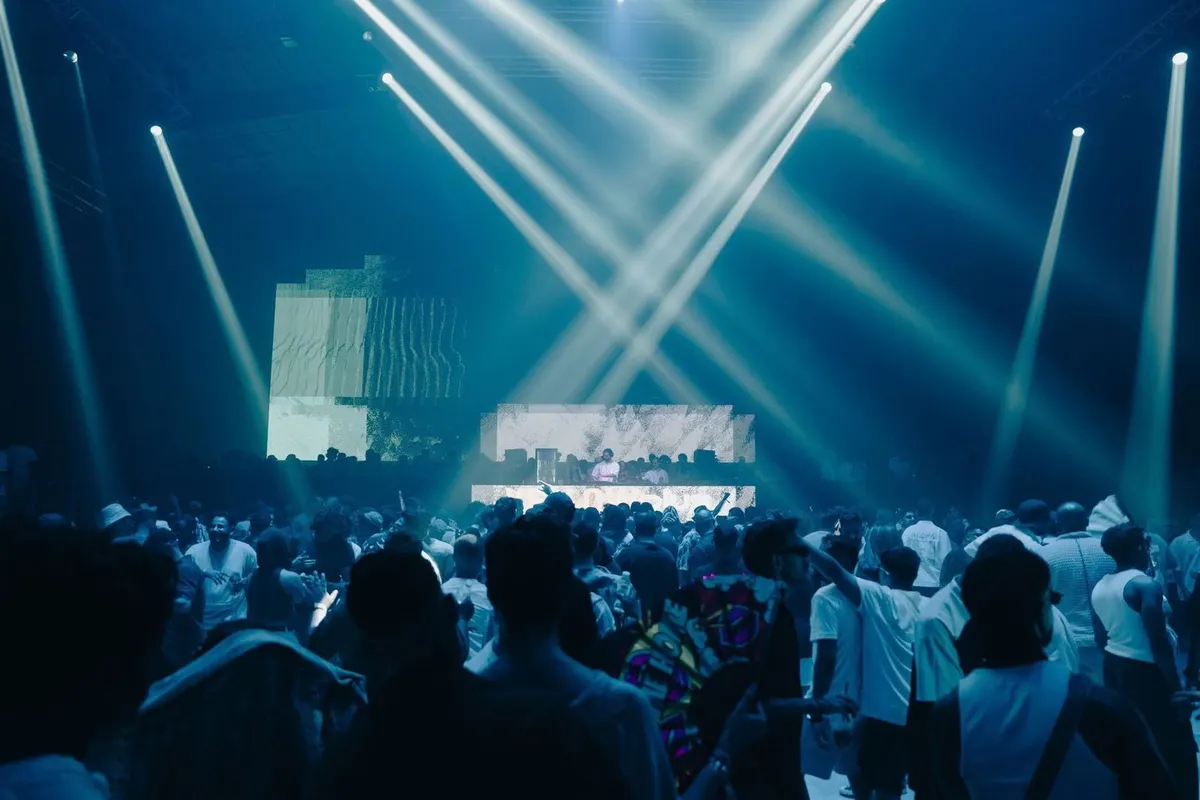 A concert crowd under stage lights
